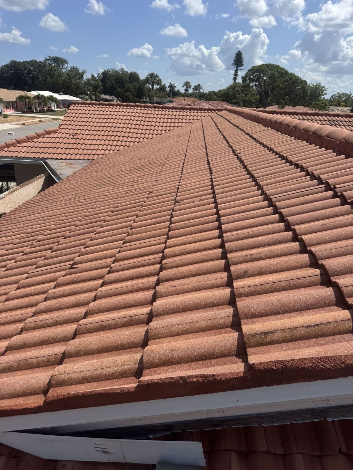 The same barrel tile roof after soft washing, back to a bright terracotta