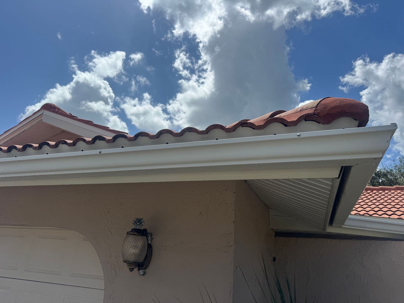 The same gutter and fascia after cleaning, bright white again