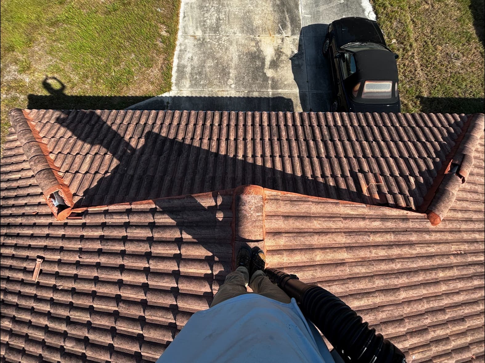 Weathered terracotta tile roof before cleaning